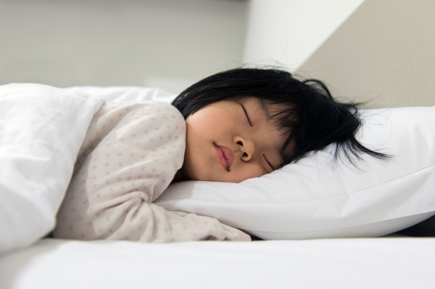 Portrait of Asian child sleeping on the bed